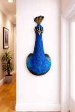 Load image into Gallery viewer, Decorative peacock head mounted on a wall in a room with a plant and framed picture.