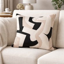 Load image into Gallery viewer, Decorative pillow with black and beige abstract pattern on a beige sofa