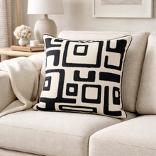 Load image into Gallery viewer, Decorative pillow with geometric pattern on a beige sofa in a living room setting.