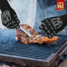 Load image into Gallery viewer, Black silicone BBQ gloves with white 'LET'S BBQ' branding, shown being used on a grill to handle a cooked steak. A red 'LET'S BBQ' logo badge is in the top right corner.