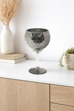 Load image into Gallery viewer, Decorative glassware on a white surface with wooden cabinets and plants in the background