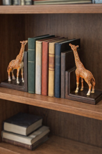 Load image into Gallery viewer, Giraffe bookends on a wooden shelf with books