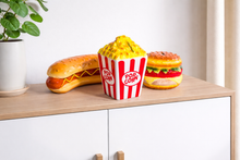 Load image into Gallery viewer, Toy hot dog, popcorn bucket, and toy hamburger on a wooden shelf with a white background