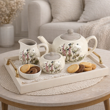 Load image into Gallery viewer, Tea set with floral patterns on a tray with cookies on a table.