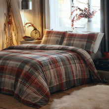 Load image into Gallery viewer, Plaid bedspread on a bed in a cozy bedroom with soft lighting.