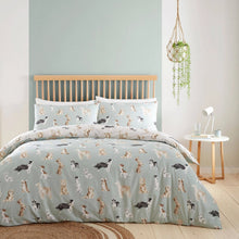 Load image into Gallery viewer, Dog patterned bedding set on a bed in a bedroom with a light blue wall.