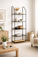 Load image into Gallery viewer, Black metal shelf in a living room with decor items.