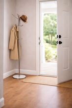 Load image into Gallery viewer, Coat rack with a coat and hat next to an open door leading outside.
