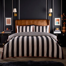Load image into Gallery viewer, Bedroom with a bed featuring black and white striped bedding, brown headboard, and dark walls.