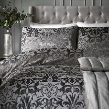 Load image into Gallery viewer, Decorative bedspread with intricate black and gray pattern on a bed with tufted headboard.