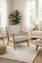 Load image into Gallery viewer, Cozy living room with a wooden armchair, coffee table, and sofa.