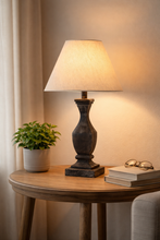 Load image into Gallery viewer, Table lamp on a wooden side table with a plant, books, and glasses in a cozy room setting.