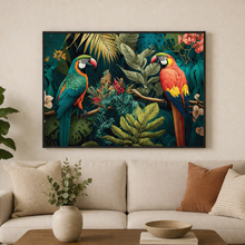Load image into Gallery viewer, Framed artwork of parrots and foliage above a beige sofa with decorative pillows and a plant.