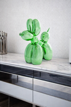 Load image into Gallery viewer, Green balloon dog sculptures on a marble surface with a gray wall background