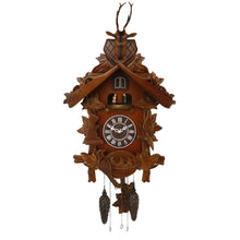 Load image into Gallery viewer, An ornate hand-carved wooden cuckoo clock with a brown finish, featuring leaf and branch details, a clock face with Roman numerals, and two hanging pinecones below, shown against a plain white background.