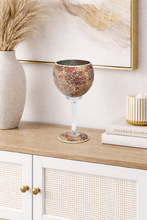 Load image into Gallery viewer, Decorative wine glass on a wooden surface with a white cabinet and abstract art in the background.