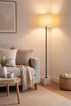 Load image into Gallery viewer, Cozy living room with a gray sofa, floor lamp, and decorative items.