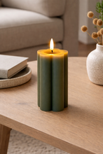 Load image into Gallery viewer, Green candle on a wooden table with a blurred background