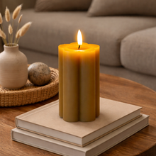 Load image into Gallery viewer, Candle burning on a stack of books with a cozy living room background