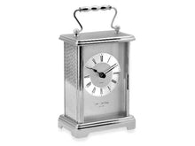 Load image into Gallery viewer, A silver metallic mantel clock with a ribbed glass front, Roman numerals, and a curved top handle, shown on a plain white background.