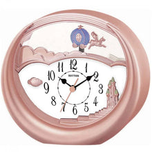Load image into Gallery viewer, A round rose gold wall clock with a whimsical Cinderella Castle design. The clock features a white face with black numbers and hands, a central rose gold sun, and decorative illustrations of Cinderella's carriage, cloud, and castle on a light pink background.