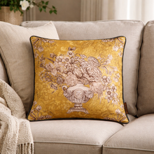 Load image into Gallery viewer, Decorative yellow pillow with floral and vase design on a beige sofa.