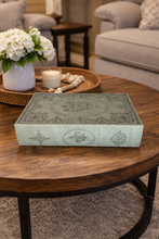 Load image into Gallery viewer, Decorative box on a wooden coffee table with flowers and candles in the background