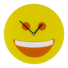 Load image into Gallery viewer, A round yellow wall clock featuring a minimalist smiley face design with orange eyes and a wide open smile showing white teeth, with black hands and a silver center screw.
