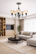 Load image into Gallery viewer, Modern living room with a chandelier, sofa, and round coffee table.

