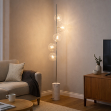 Load image into Gallery viewer, Modern living room with a floor lamp, sofa, and coffee table.
