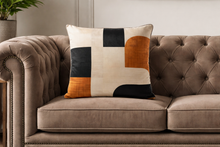 Load image into Gallery viewer, Decorative pillow with geometric pattern on a brown sofa
