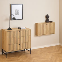 Load image into Gallery viewer, Wooden cabinet and wall-mounted shelf against a beige wall with decorative items.

