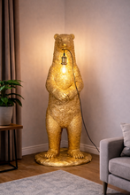 Load image into Gallery viewer, Gold bear-shaped floor lamp in a room with a plant and sofa.
