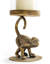 Load image into Gallery viewer, Bronze monkey candle holder with a candle on a white background
