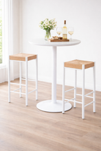 Load image into Gallery viewer, White bar table with two wooden stools on a light wood floor.
