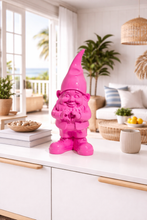 Load image into Gallery viewer, Pink gnome figurine on a white surface in a bright living room.
