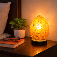 Load image into Gallery viewer, Decorative lamp on a bedside table with a book, glasses, and plant in the background.
