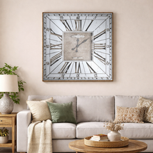 Load image into Gallery viewer, Decorative wall clock above a sofa in a living room setting
