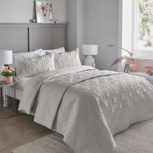 Load image into Gallery viewer, Neatly made bed with patterned bedding in a bedroom setting.
