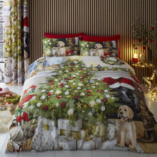 Load image into Gallery viewer, Christmas-themed bedding set with a tree, presents, and dogs on a bed.
