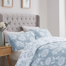 Load image into Gallery viewer, Bedroom with floral bedding and a tufted headboard
