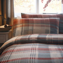 Load image into Gallery viewer, Plaid bedding set on a bed with pillows in a bedroom setting.
