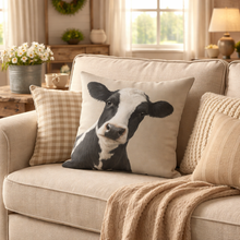 Load image into Gallery viewer, Beige sofa with a cow-patterned pillow in a cozy living room setting.
