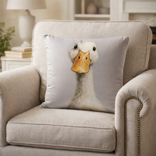 Load image into Gallery viewer, Decorative pillow with a duck design on a beige armchair in a home setting.
