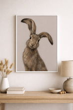 Load image into Gallery viewer, Framed artwork of a rabbit on a wall above a wooden console table with decor items.
