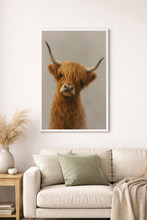 Load image into Gallery viewer, Framed artwork of a highland cow on a wall above a sofa in a living room.
