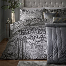 Load image into Gallery viewer, Decorative bedspread with intricate patterns on a bed in a bedroom setting.

