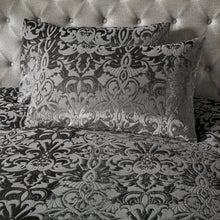 Load image into Gallery viewer, Decorative pillows with intricate patterns on a bed with a tufted headboard.
