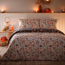 Load image into Gallery viewer, Bed with floral bedding in a cozy bedroom setting with candles and pumpkins.

