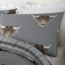 Load image into Gallery viewer, Gray pillowcases with highland cow design on a bed with plaid bedding.
